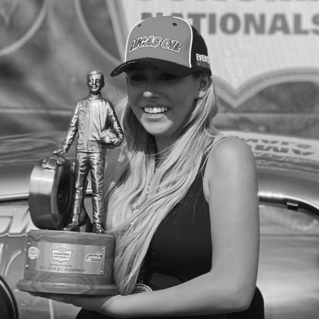 Shelby Williams holding her NHRA trophy